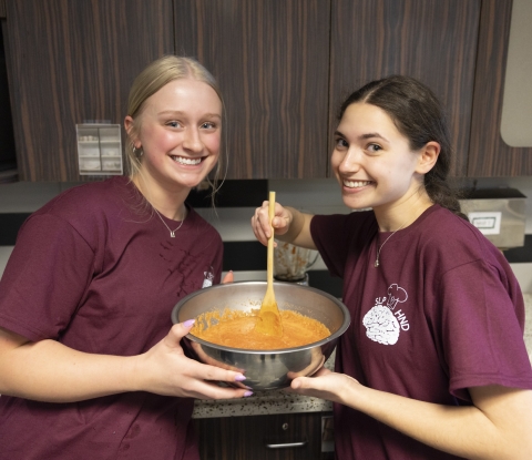 Two female student cooking