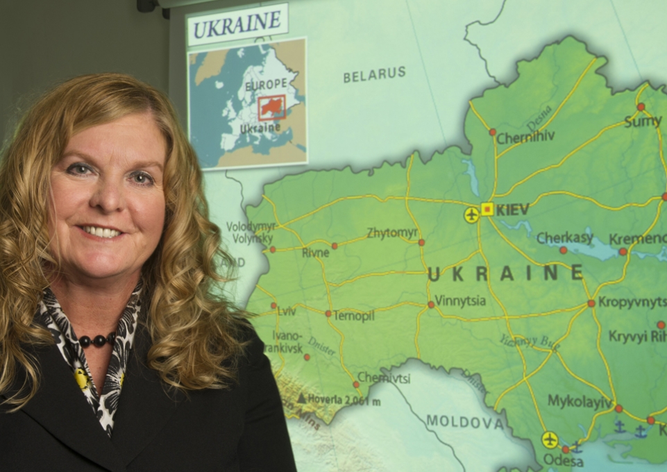 Kimberly Kline standing in front of a map of Ukraine