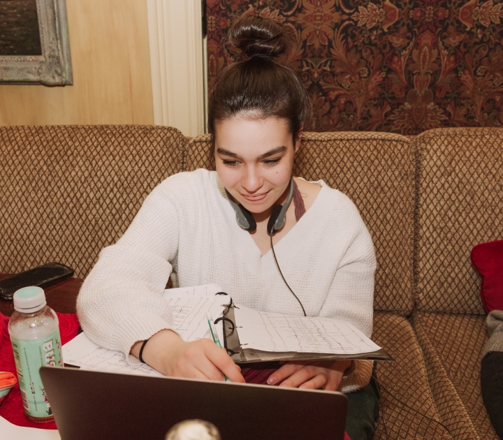 Zoe Gonez using laptop on film set