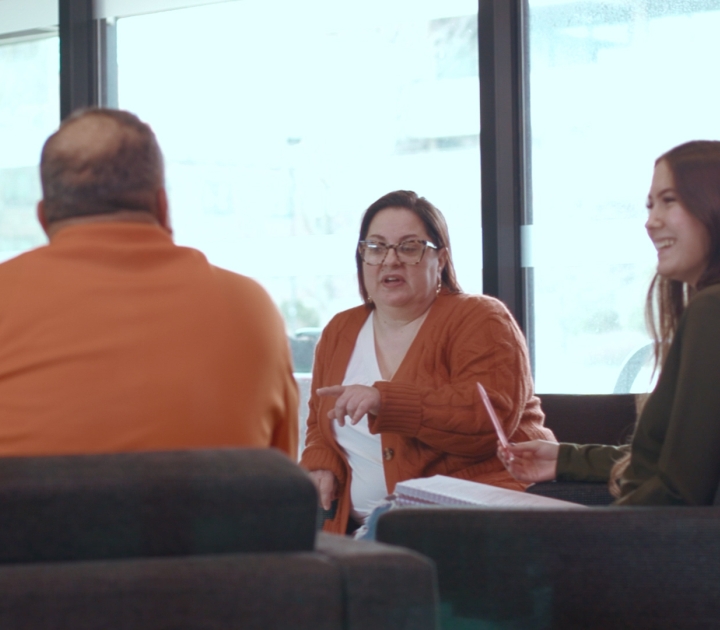 Female professor talking to two students