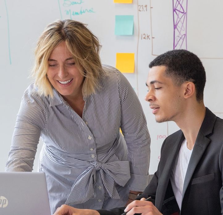Faculty and student working on a laptop
