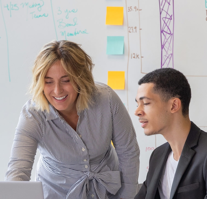 Faculty and student working on a laptop
