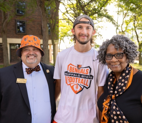 Vice President for Student Affairs Tim Gordon and Interim President Bonita Durand posing for a photo with a new student on Move-In Day 2023