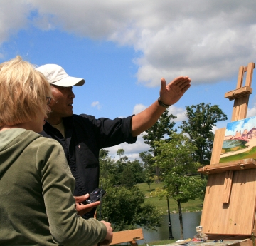 Student and faculty in an outdoor painting class