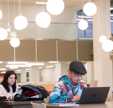 Students with laptops in Academic Commons