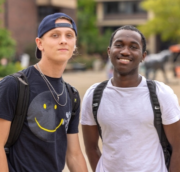 Two smiling students in Buffalo State's Student Union Plaza