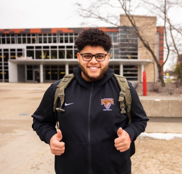 Student giving two thumbs up