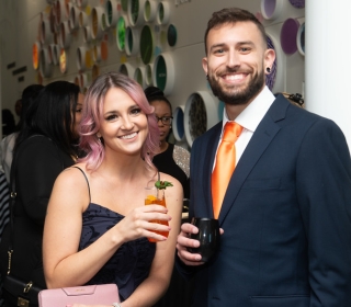 Two smiling students holding drinks at the 2022 Bengala