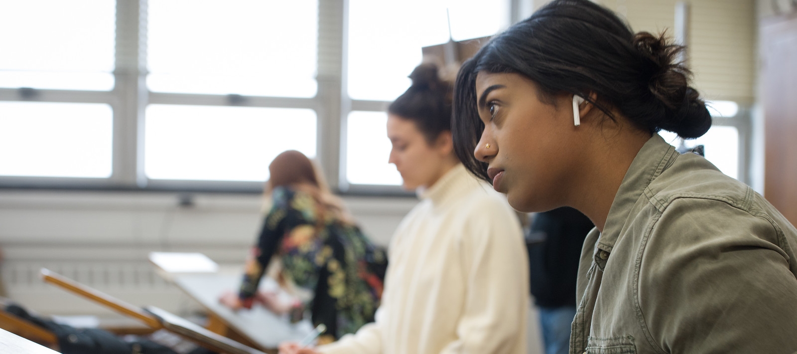 Student at drawing board in art studio