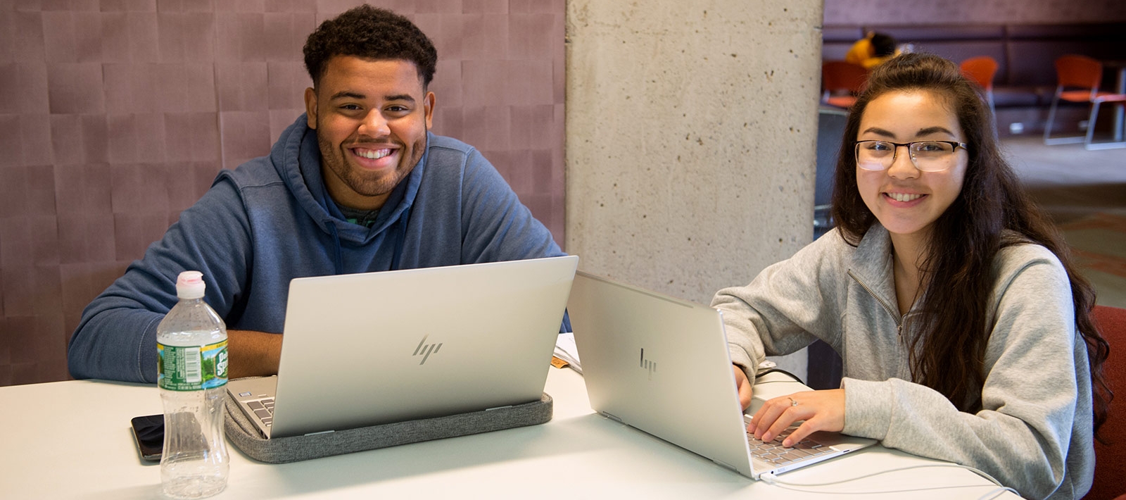 Students with laptops at a table
