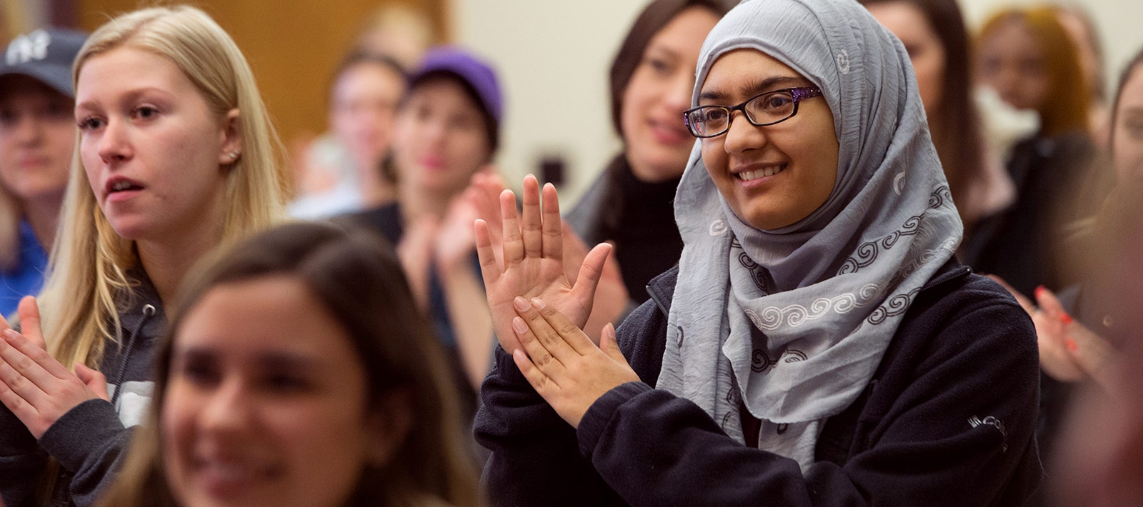 Students clapping in a group