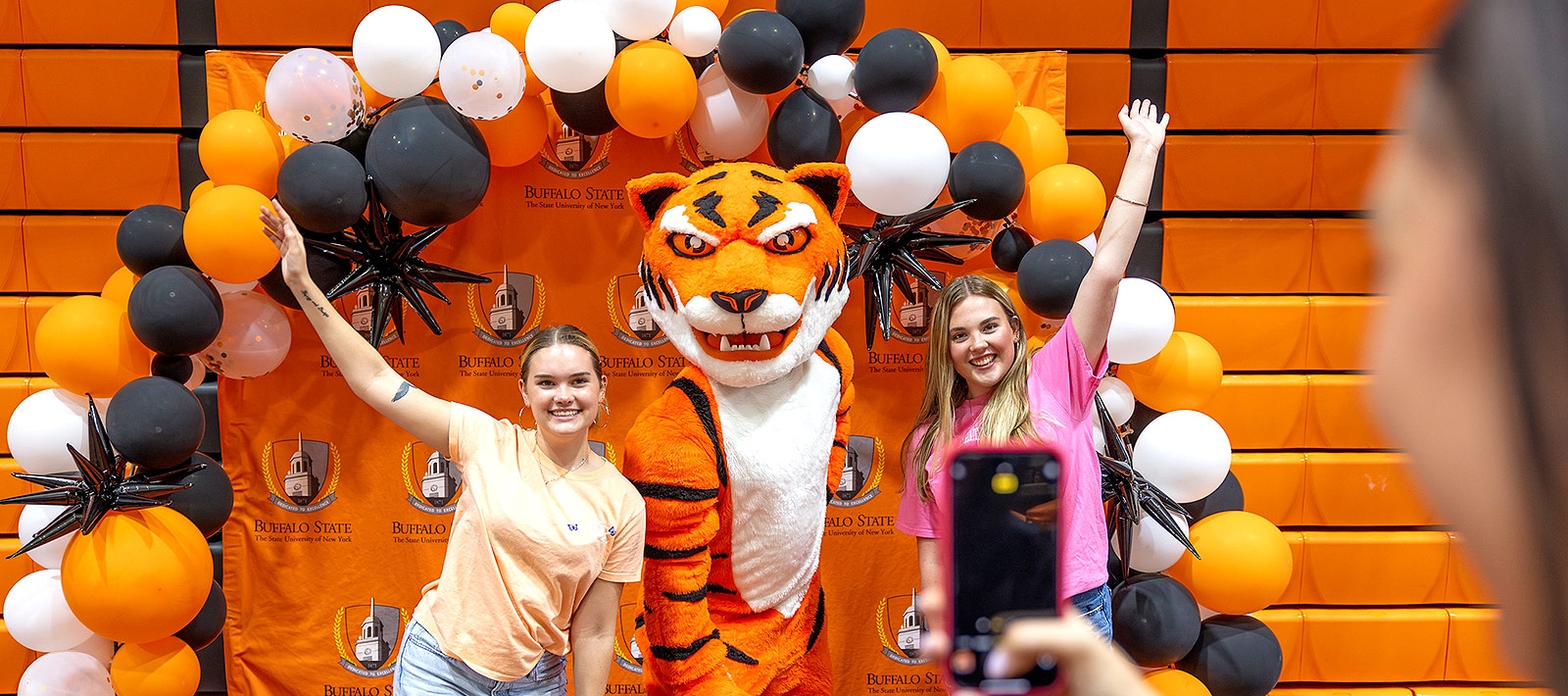 Students in a balloon arch, posing with the Bengal