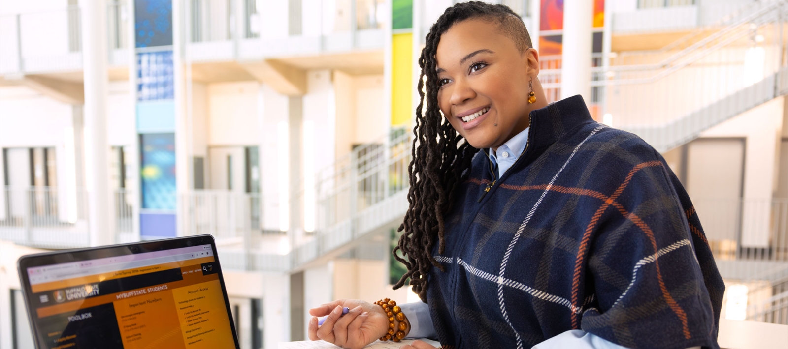Student with a laptop in the Technology Building