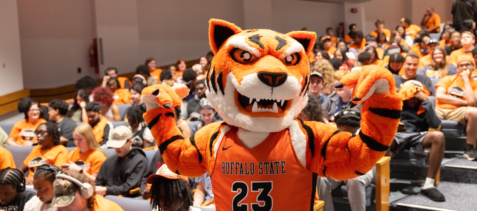 Buffalo State mascot stands in front of seated students
