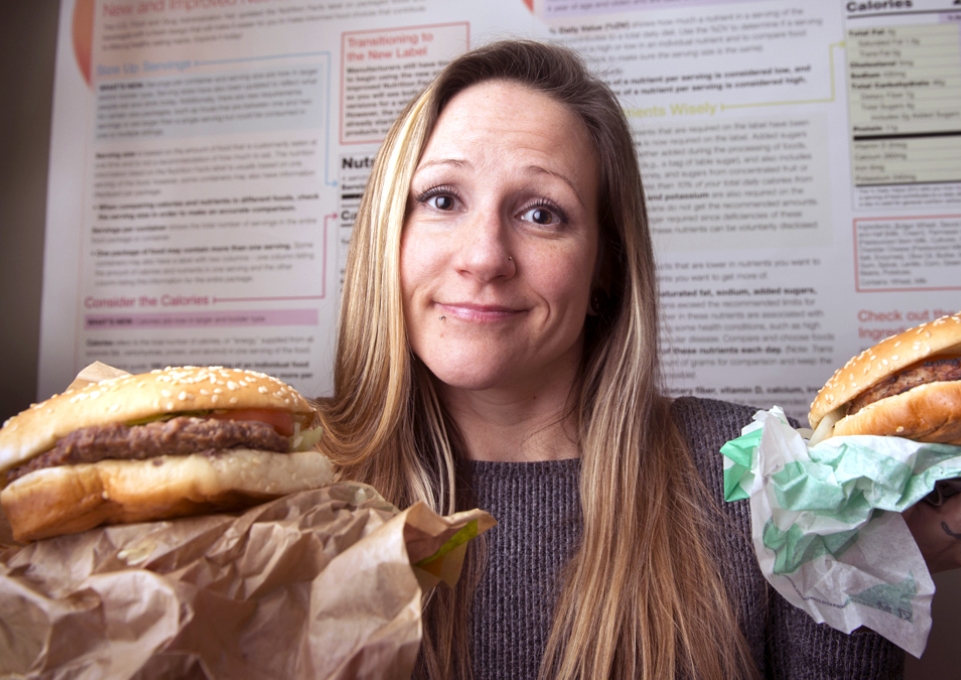 Liz Hartz holding two burgers